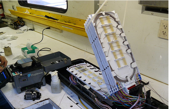 1559_An underground fiber optic splice enclosure opens for splicing.png